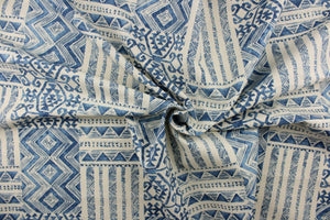  This fabric features a geometric design in blue and natural or off white. 