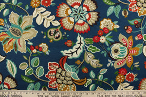This outdoor fabric features a floral print and foliage set against a blue background.   Colors include red, green, off white, taupe, gold, purple and brown.