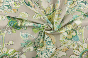  This printed fabric features a floral design in colors of green, teal and gold on a gray background. 