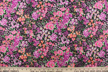 Load image into Gallery viewer, This quilting print features a floral design in varying shades of pink, purple, green and pale orange with hints of white against a black background. 
