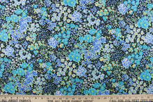 Load image into Gallery viewer, This quilting print features a floral design in varying shades of blue, teal, and yellow, green with hints of white against a black background. 
