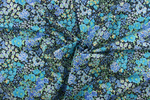 Load image into Gallery viewer, This quilting print features a floral design in varying shades of blue, teal, and yellow, green with hints of white against a black background. 
