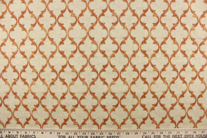  This fabric features a geometric design in orange on a off white background.