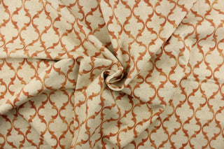  This fabric features a geometric design in orange on a off white background.