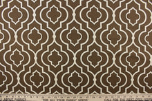 Load image into Gallery viewer, This fabric features a geometric design in white with black outline against a brown background.
