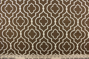 This fabric features a geometric design in white with black outline against a brown background.