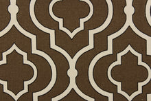 Load image into Gallery viewer, This fabric features a geometric design in white with black outline against a brown background.
