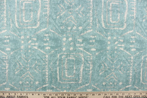 This fabric feature a geometric design resembling an Aztec design in white against a light blue.