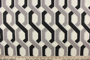 This fabric features a link design in gray, black and white.