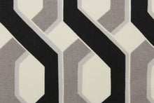 Load image into Gallery viewer, This fabric features a link design in gray, black and white.
