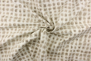  This fabric features a geometric design of small squares in brown gray tones against a off white background. 