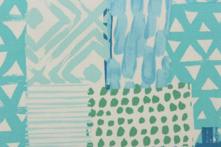This fabric features a geometric design in shades of turquoise blue, green and white.
