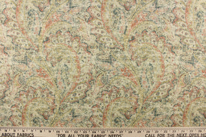 This fabric features a distressed paisley design in shades of brick red, blue green, hints of beige, yellow and off white. 