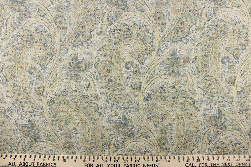  This fabric features a distressed paisley design in shades of blue, beige, hints of gray, yellow and off white. 