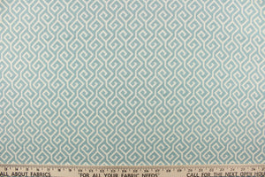 This fabric features a geometric design in light blue and off white. 