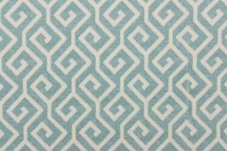 This fabric features a geometric design in light blue and off white. 