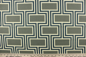 This fabric features a geometric design in blue, gray with green undertones, and off white. 
