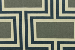 This fabric features a geometric design in blue, gray with green undertones, and off white. 