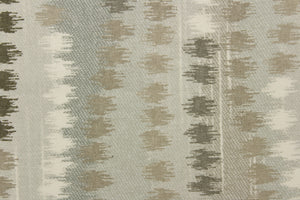  This fabric features an abstract design in gray, off white, and beige. 