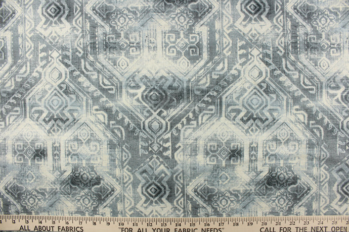 This fabric features a unique geometric design in shades of blue gray and off white.