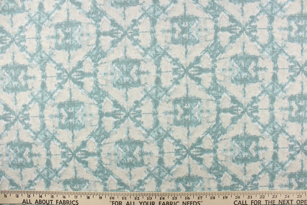  This geometric design in light gray, pale blue, and hints of teal and white offer a modern look.