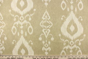  This fabric features an ikat design in a khaki and off white.