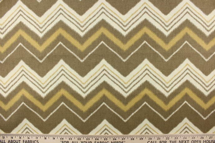  This fabric features a chevron design in varying taupe, khaki and off white. 