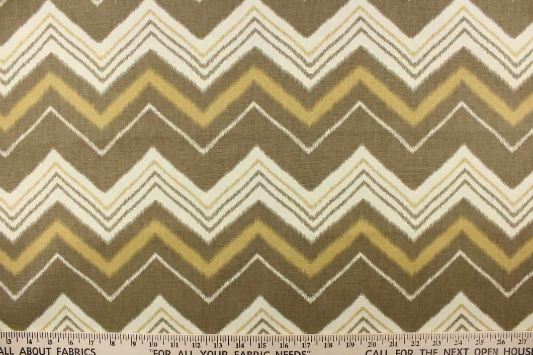  This fabric features a chevron design in varying taupe, khaki and off white. 
