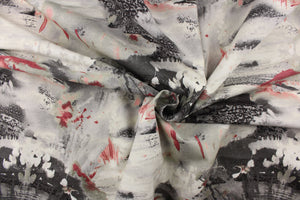  This fabric features an abstract design in gray, pink, and white. 
