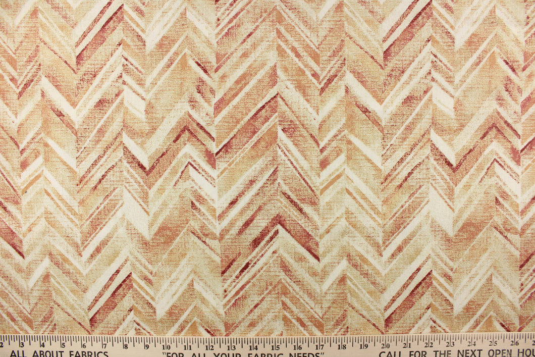  This fabric features a chevron design in shades of red, orange, pale khaki and white .