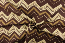 Load image into Gallery viewer, This fabric features a chevron design in varying shades of brown.
