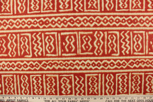 This fabric features a Aztec design in red and light khaki with hints of orange. 