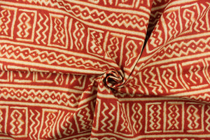 This fabric features a Aztec design in red and light khaki with hints of orange. 
