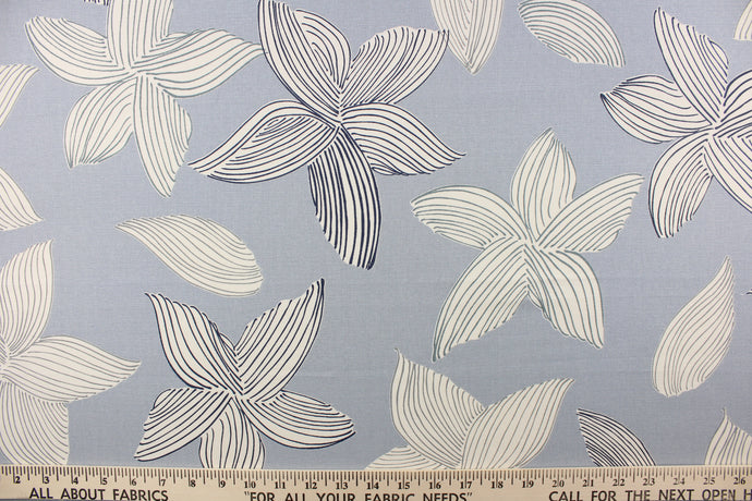  This fabric features a contemporary floral design in blue and off white. 