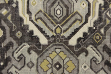 Load image into Gallery viewer, This fabric features an Aztec design in mute gold, shades of gray, and off white with hints of black. 
