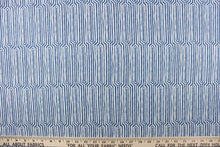 Load image into Gallery viewer, This fabric features a geometric design in a dull white against a denim blue. 

