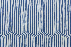 This fabric features a geometric design in a dull white against a denim blue. 