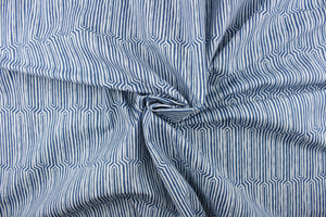 This fabric features a geometric design in a dull white against a denim blue. 