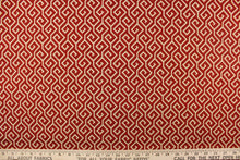 Load image into Gallery viewer, This fabric features a geometric design in beige against a deep red.
