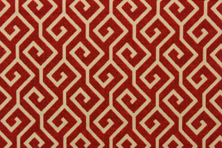This fabric features a geometric design in beige against a deep red.