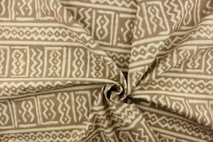 This fabric features a Aztec design in off white against a taupe background. 