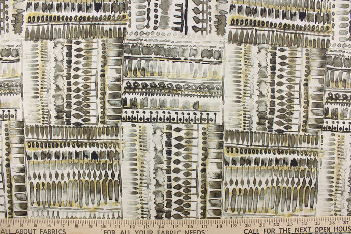 This fabric features an abstract design in gray, black, gold tone and white.