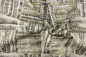 This fabric features an abstract design in gray, black, gold tone and white.