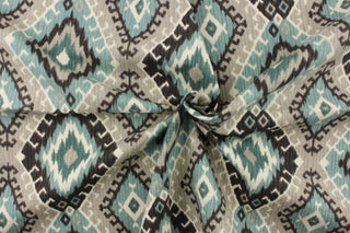  This fabric features a geometric design of diamonds in varying shades of teal, and gray with hints of black and white