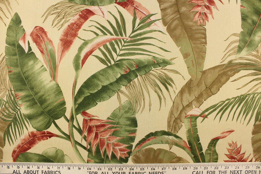 This fabric features a floral design of tropical leaves in green, brown, and rust red against a khaki color.