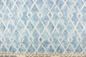 This fabric features a geometric diamond design in blue and white. 