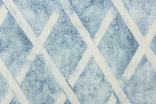 This fabric features a geometric diamond design in blue and white. 