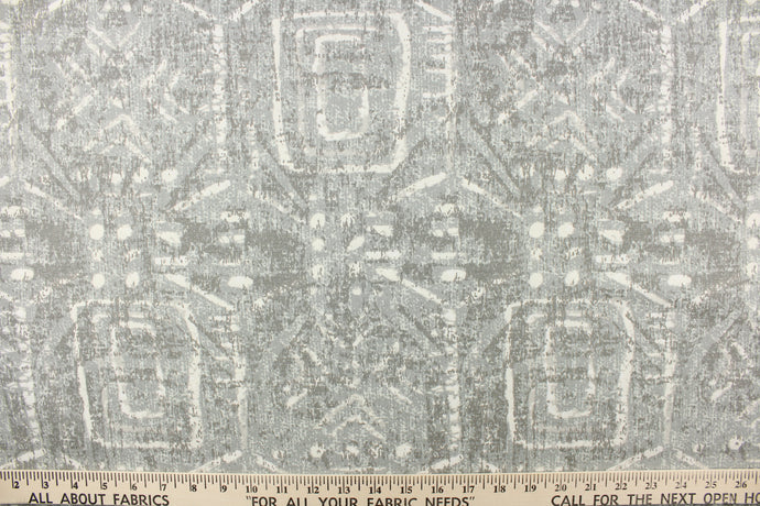 This fabric feature a geometric design resembles an Aztec design in shades of gray with hints of dull white.