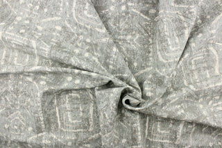 This fabric feature a geometric design resembles an Aztec design in shades of gray with hints of dull white.