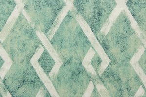 This fabric features a geometric diamond design in a blue green and dull white.